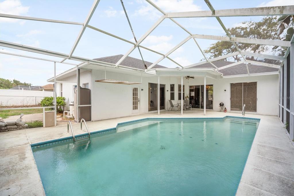 7282 Aloe Drive Spring Hill, FL 34607 - Photo 20 of 25 a view of a patio with a table and chairs under an umbrella