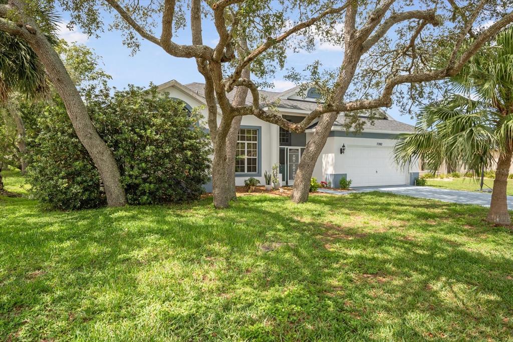 7282 Aloe Drive Spring Hill, FL 34607 - Photo 2 of 25 a house view with a garden space