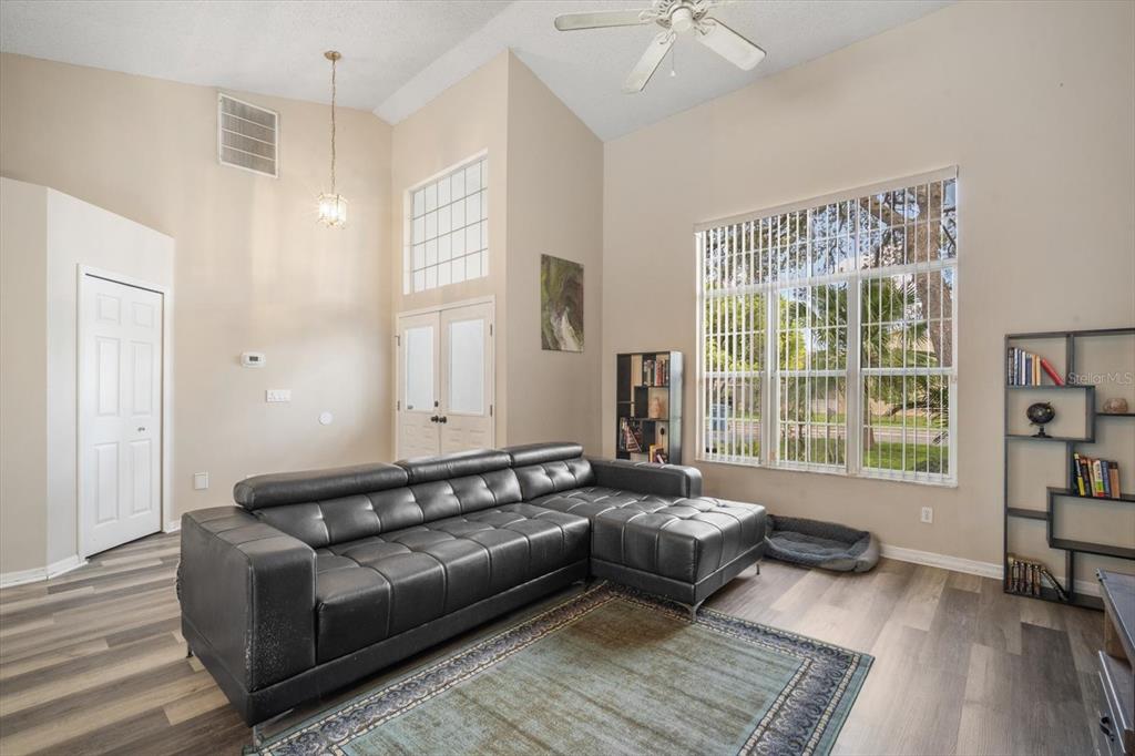7282 Aloe Drive Spring Hill, FL 34607 - Photo 4 of 25 a living room with furniture and a large window
