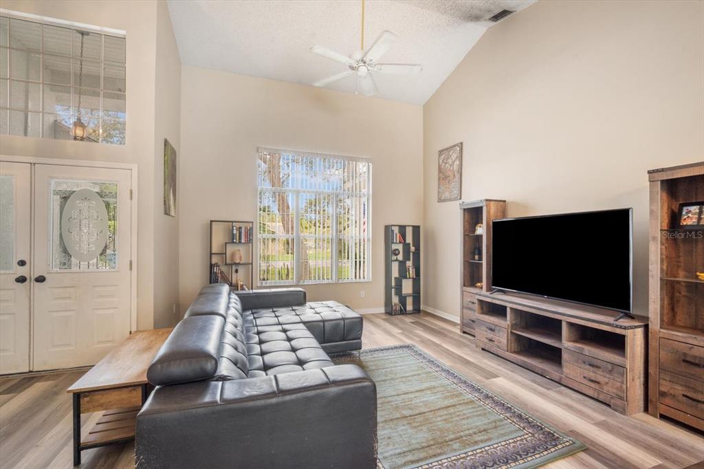 7282 Aloe Drive Spring Hill, FL 34607 - Photo 5 of 25 a living room with furniture and a flat screen tv