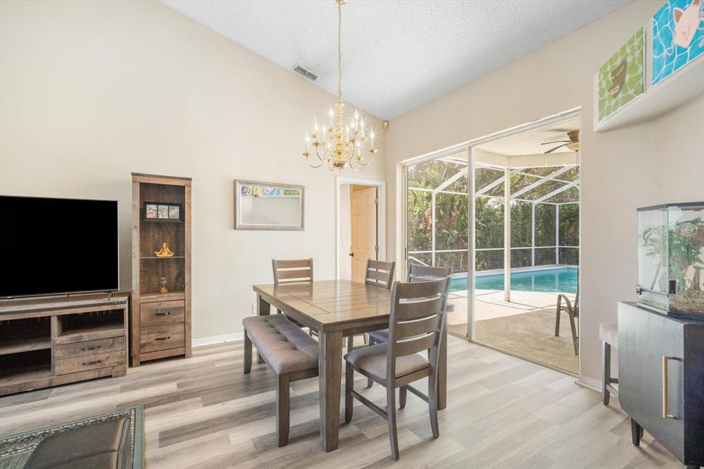 7282 Aloe Drive Spring Hill, FL 34607 - Photo 6 of 25 a dining room with wooden floor and windows