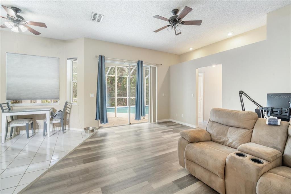 7282 Aloe Drive Spring Hill, FL 34607 - Photo 7 of 25 a living room with furniture and a ceiling fan
