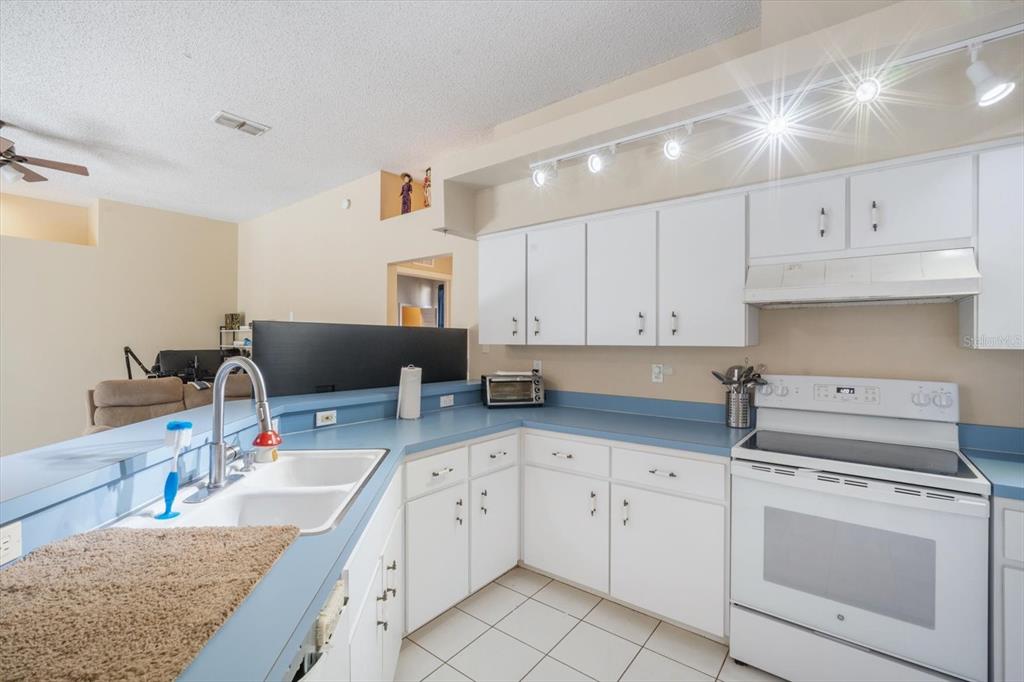 7282 Aloe Drive Spring Hill, FL 34607 - Photo 10 of 25 a kitchen with granite countertop a sink a stove and cabinets