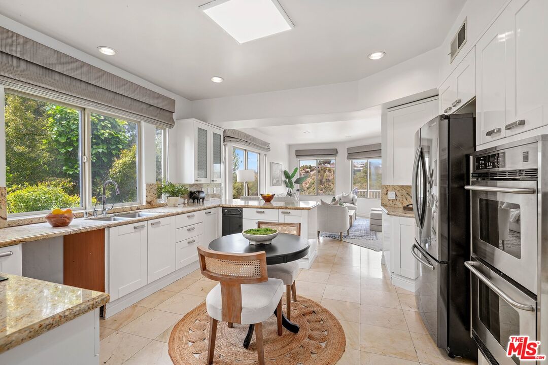 1991 Stradella Road Los Angeles, CA 90077 - Photo 11 of 26 a kitchen with a refrigerator and a stove