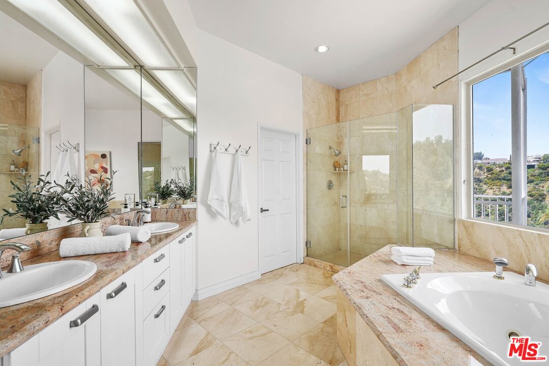 1991 Stradella Road Los Angeles, CA 90077 - Photo 17 of 26 a bathroom with a double vanity sink mirror and shower