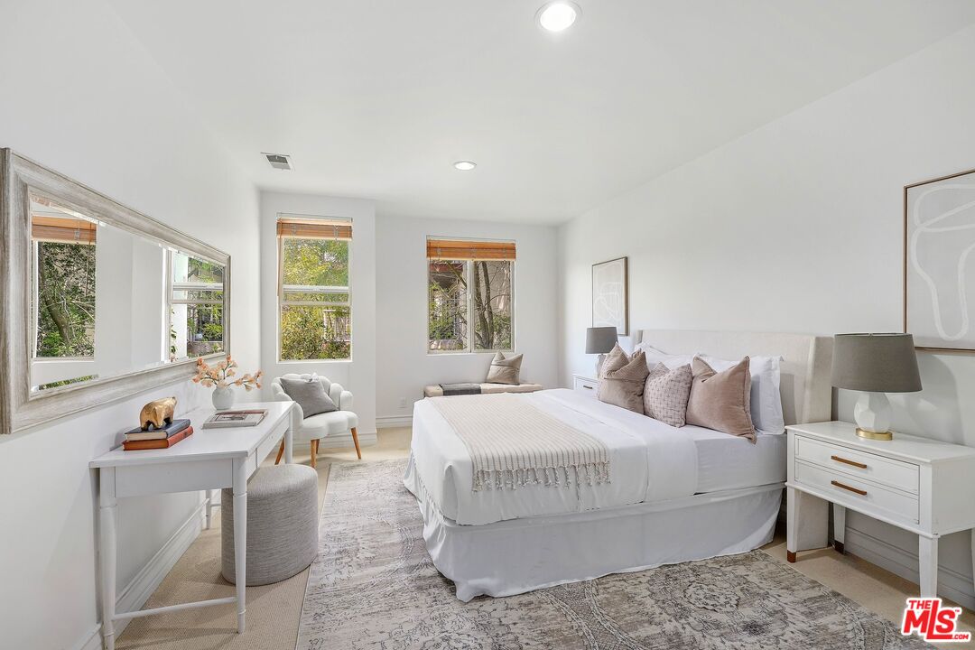1991 Stradella Road Los Angeles, CA 90077 - Photo 19 of 26 a bedroom with a bed and large windows
