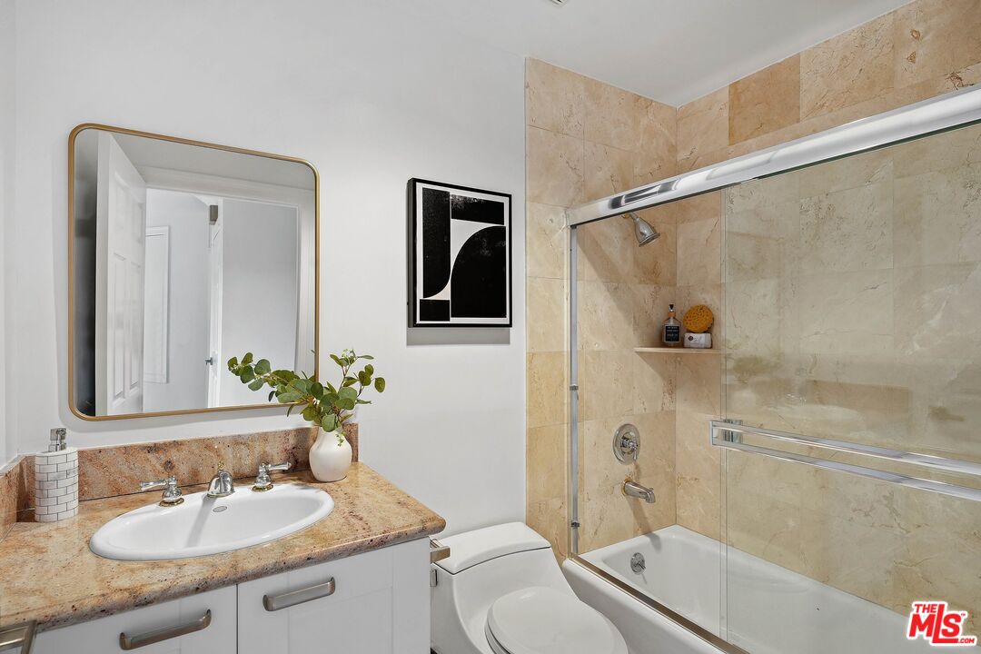 1991 Stradella Road Los Angeles, CA 90077 - Photo 20 of 26 a bathroom with a granite countertop sink toilet and shower