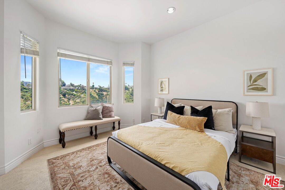 1991 Stradella Road Los Angeles, CA 90077 - Photo 21 of 26 a bedroom with a large bed and a couch