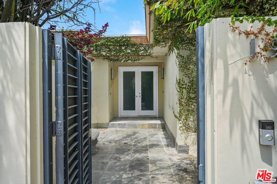 1991 Stradella Road Los Angeles, CA 90077 - Photo 4 of 26 a view of a pathway of a house with a yard and potted plants