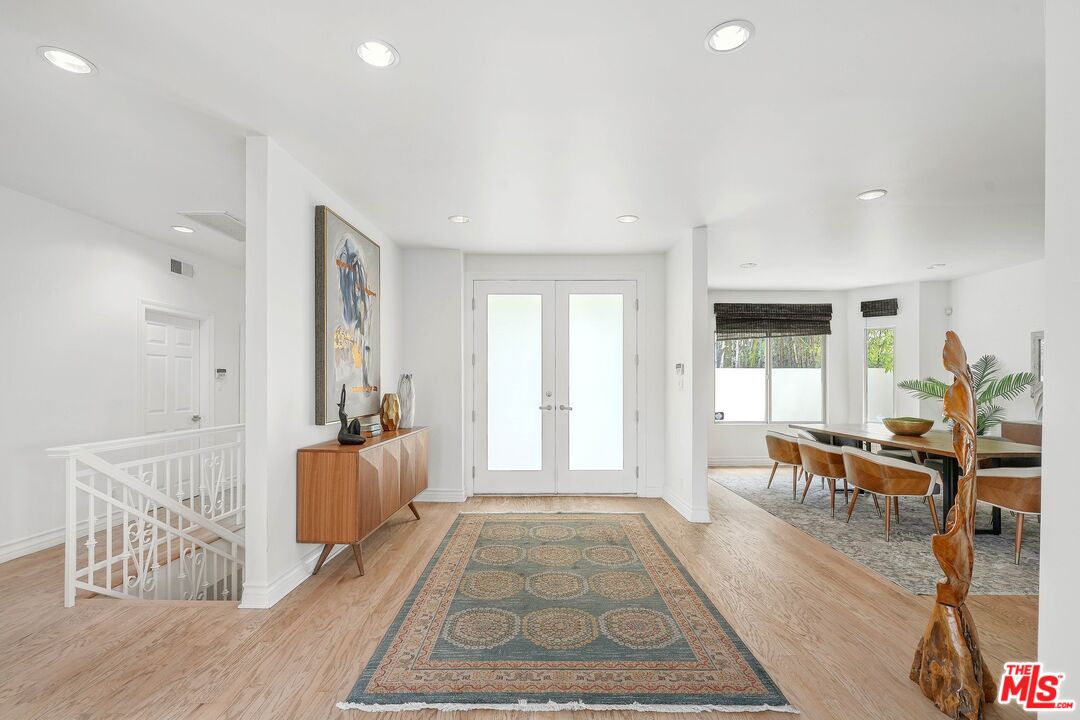 1991 Stradella Road Los Angeles, CA 90077 - Photo 5 of 26 a living room with furniture a dining table and a large window