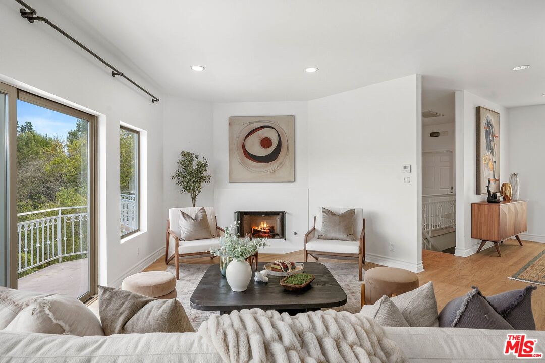 1991 Stradella Road Los Angeles, CA 90077 - Photo 7 of 26 a living room with furniture and a fireplace