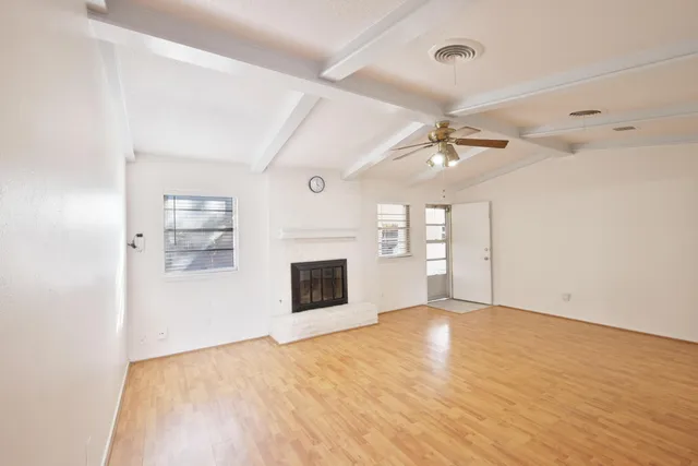 wooden floor in an empty room with a fireplace