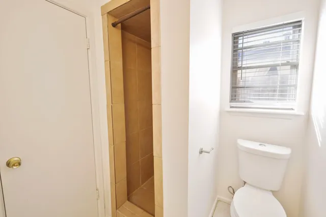 a white toilet sitting next to a bathroom sink