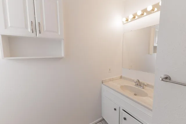 a bathroom with a sink and a mirror