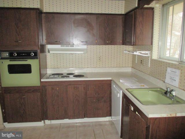 8800 Sigrid Road Randallstown, MD 21133 - Photo 5 of 16 a kitchen with a sink and cabinets