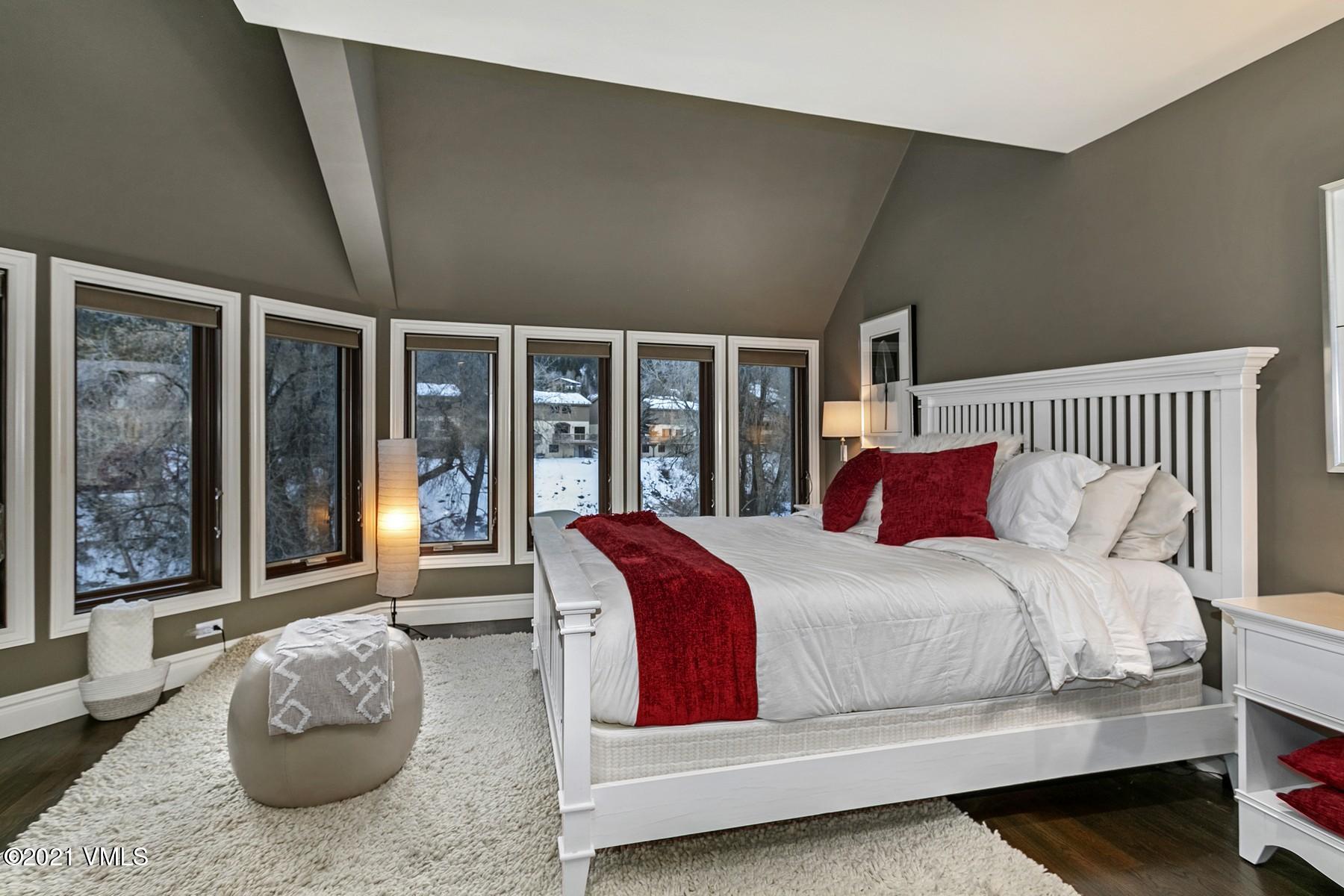 3000 Eaglebend Drive, Unit 1 Avon, CO 81620 - Photo 17 of 41 a bedroom with a bed and glass window