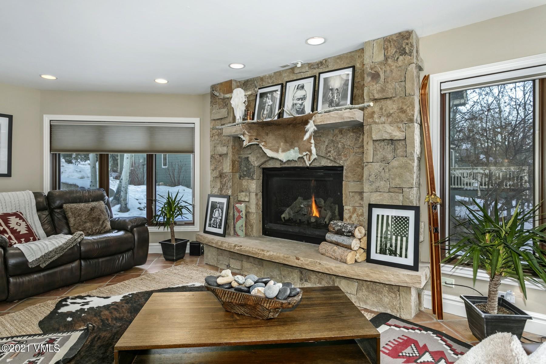 3000 Eaglebend Drive, Unit 1 Avon, CO 81620 - Photo 2 of 41 a living room with furniture large window and a fireplace