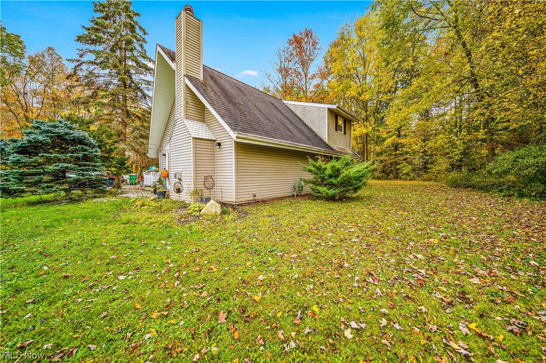 933 Long Shadow Lane Rome, OH 44085 - Photo 5 of 25 View of property exterior with a lawn