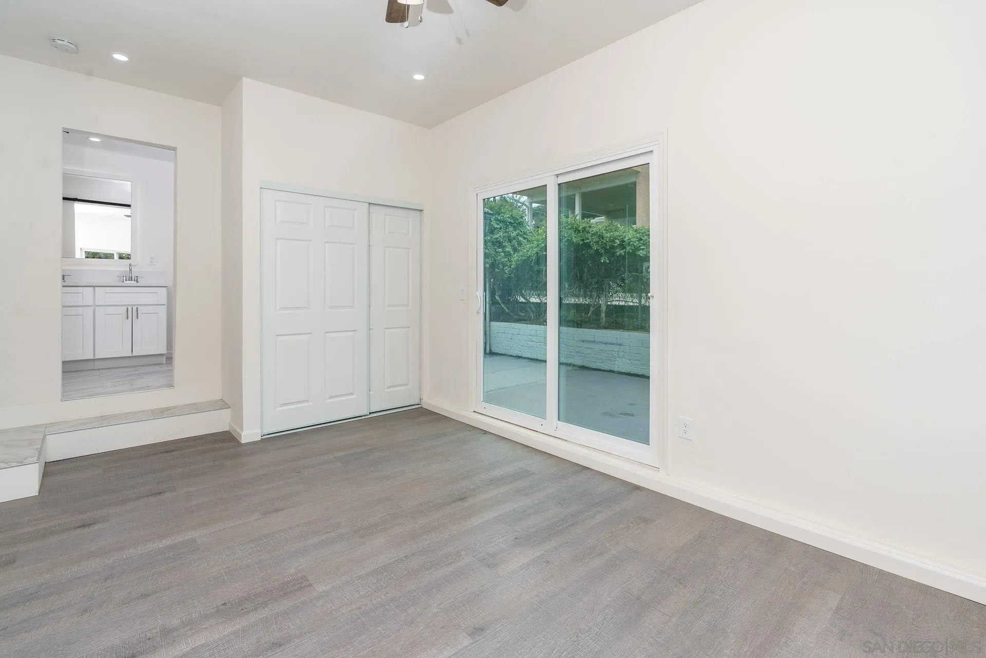 9208 Brookside Circle Spring Valley, CA 91977 - Photo 14 of 31 an empty room with wooden floor and windows
