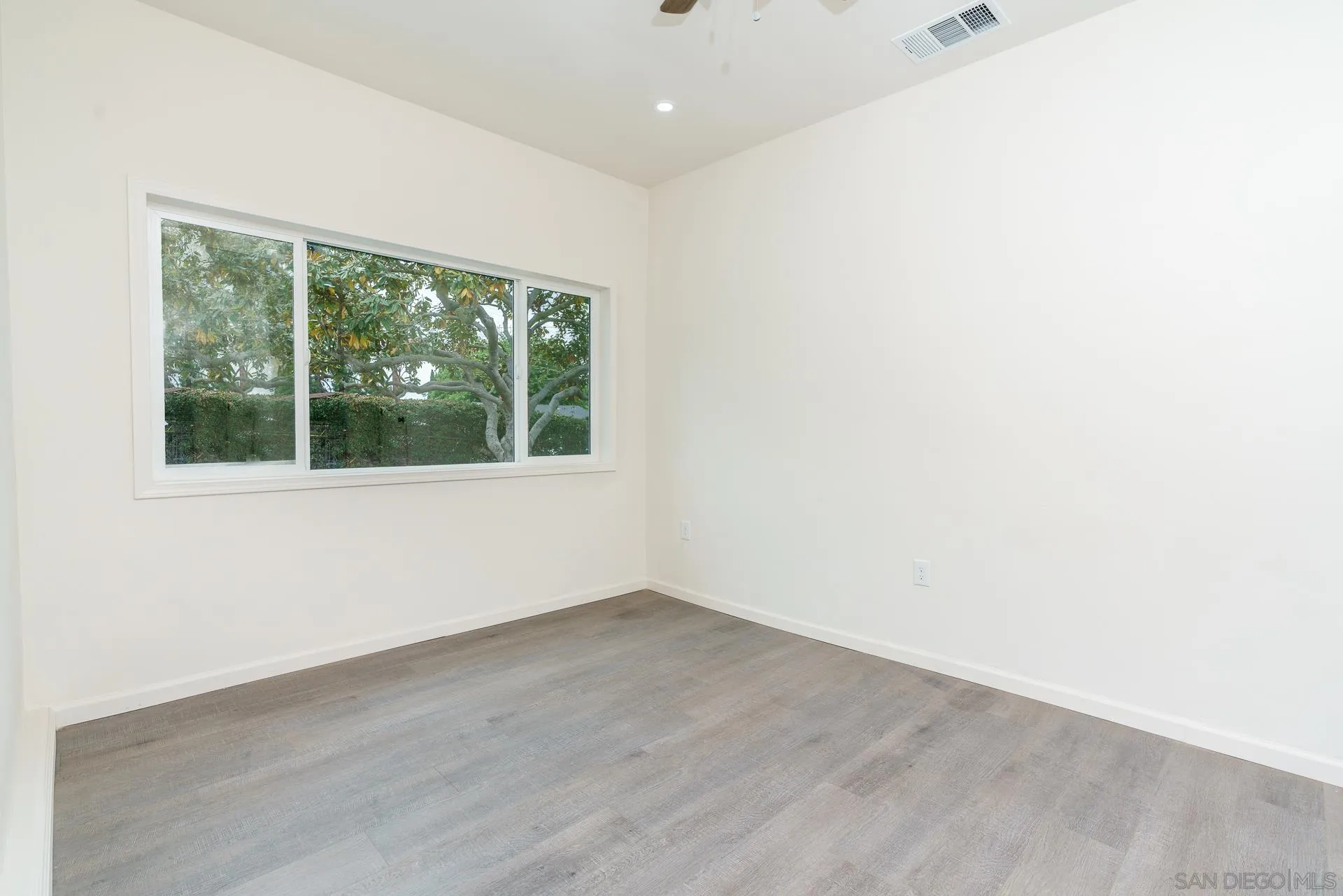 9208 Brookside Circle Spring Valley, CA 91977 - Photo 15 of 31 an empty room with wooden floor and windows