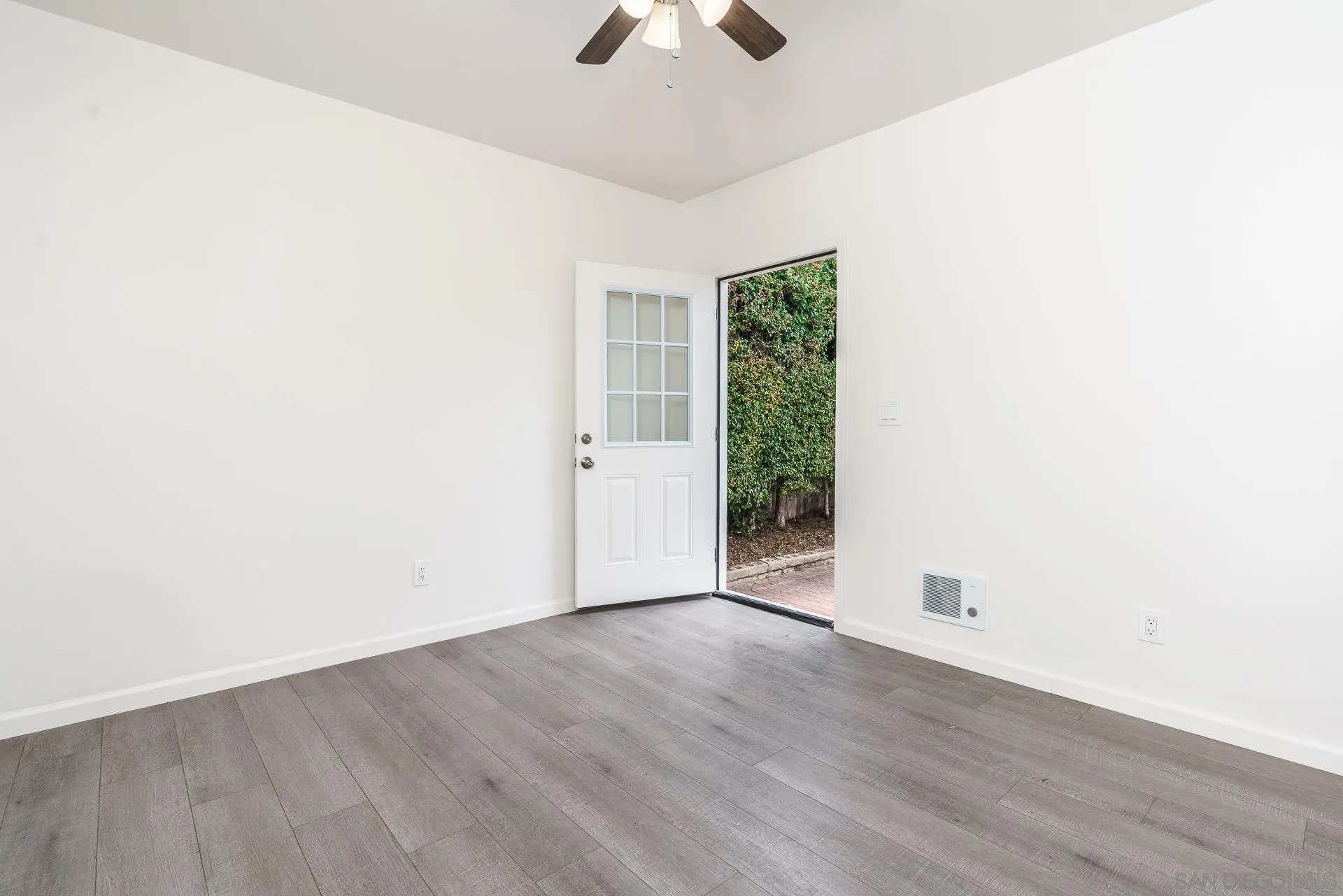 9208 Brookside Circle Spring Valley, CA 91977 - Photo 18 of 31 an empty room with a ceiling fan and wooden floor