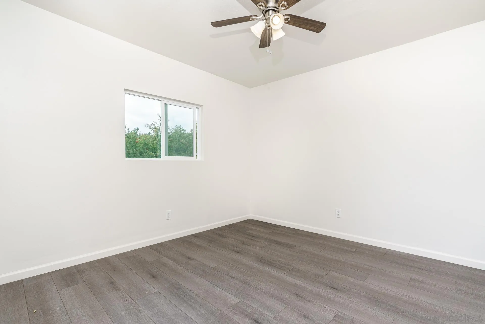 9208 Brookside Circle Spring Valley, CA 91977 - Photo 19 of 31 an empty room with wooden floor and windows