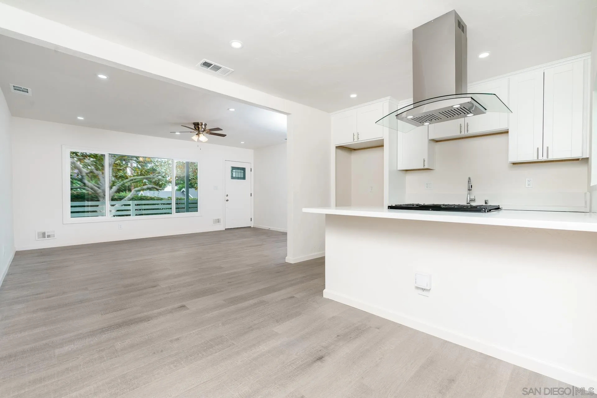 9208 Brookside Circle Spring Valley, CA 91977 - Photo 5 of 31 an empty room with wooden floor and windows