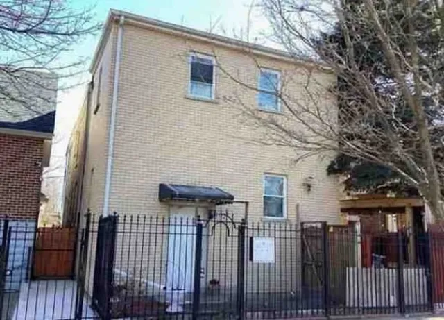a view of a house with wooden fence