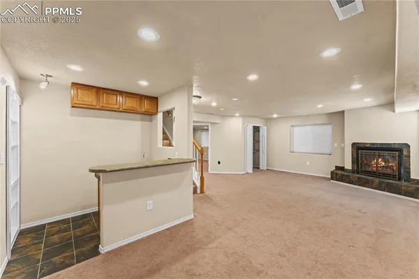 a view of an empty room with a fireplace