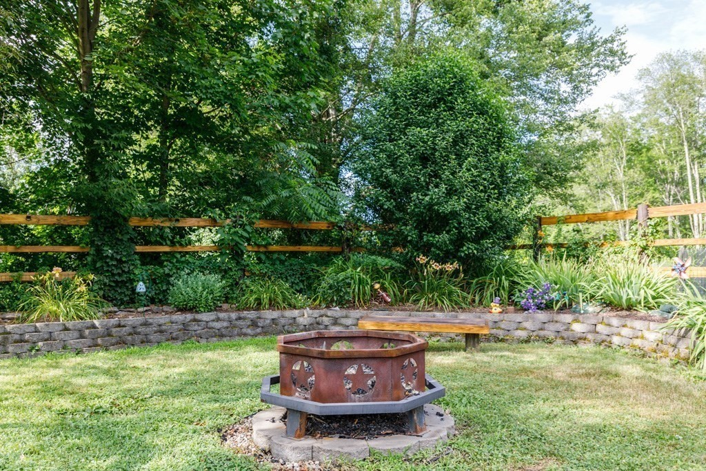 75 East Myrtle Street Orange, MA 01364 - Photo 18 of 28 a view of a backyard with plants and a fountain
