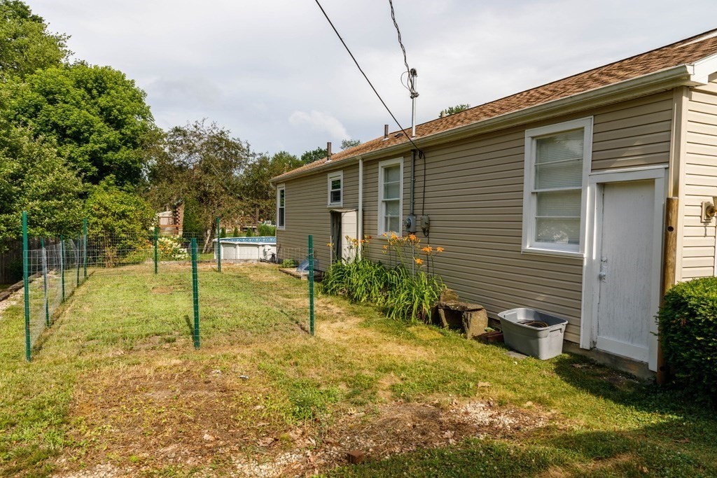 75 East Myrtle Street Orange, MA 01364 - Photo 20 of 28 a backyard of a house with table and chairs