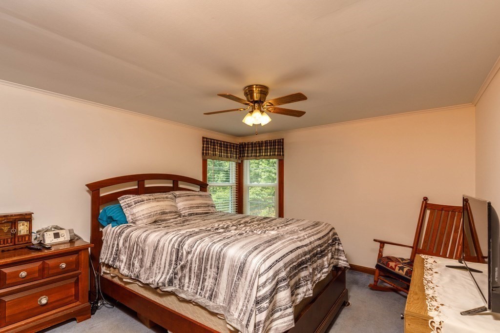 75 East Myrtle Street Orange, MA 01364 - Photo 7 of 28 a bedroom with a bed and dresser