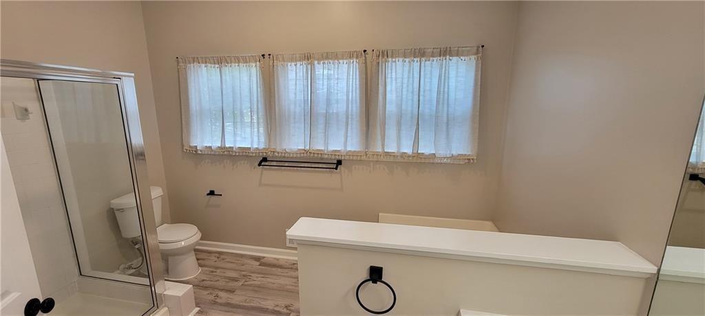 3324 Benthollow Lane Duluth, GA 30096 - Photo 11 of 16 a bathroom with a sink a toilet and a shower