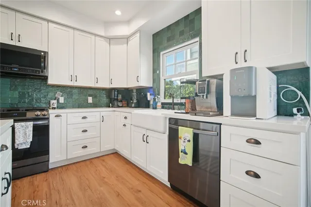 a kitchen with cabinets appliances and a window