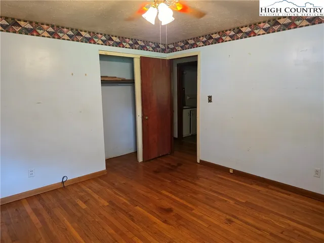 a view of a room with wooden floor