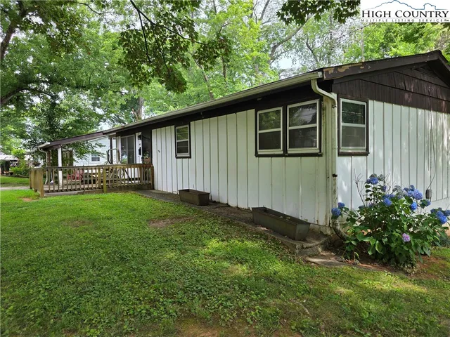 a view of a house with a yard and sitting area