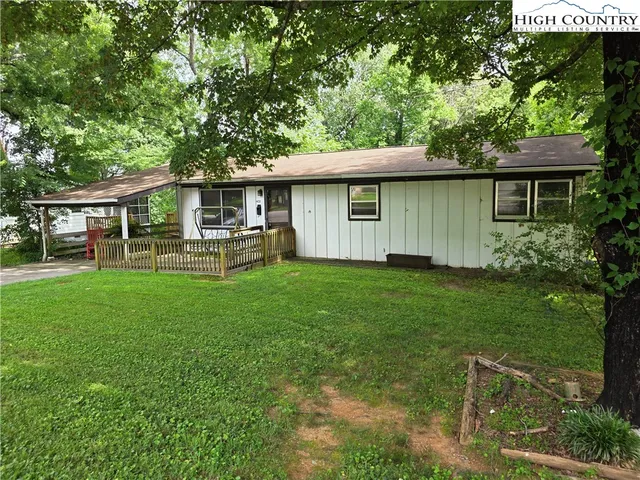 a front view of a house with a garden and yard