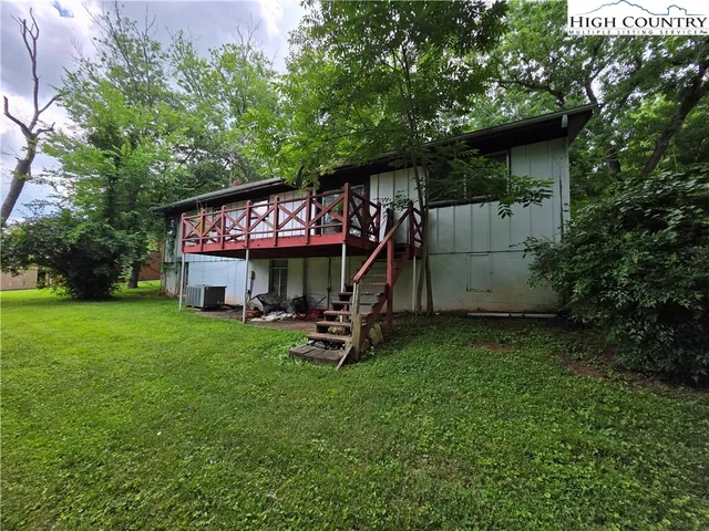 a view of a wooden fence under a large tree