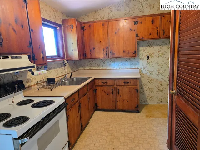 a kitchen with a sink a stove and a refrigerator