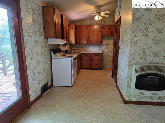 a kitchen with a sink a stove and cabinets