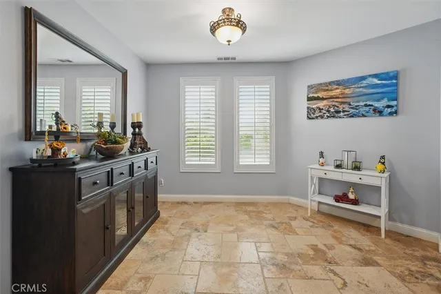 a kitchen with stainless steel appliances granite countertop a sink a stove a refrigerator and cabinets