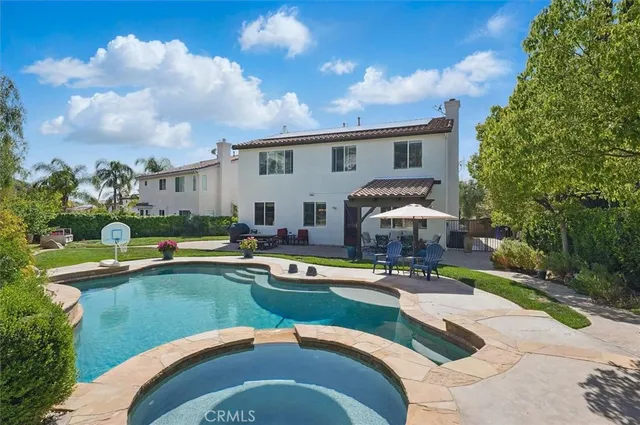 a view of a patio with a table and chairs and potted plants