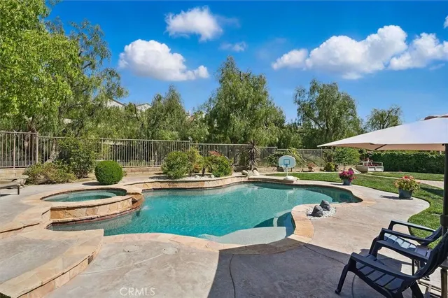 a view of a house with swimming pool and a yard