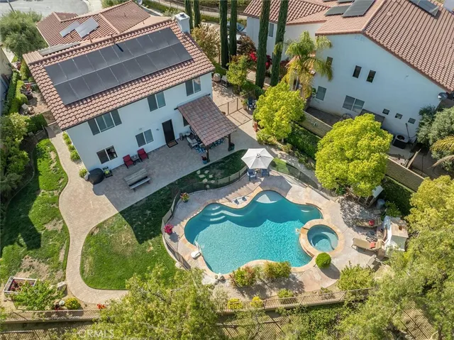a view of a house with backyard and sitting area