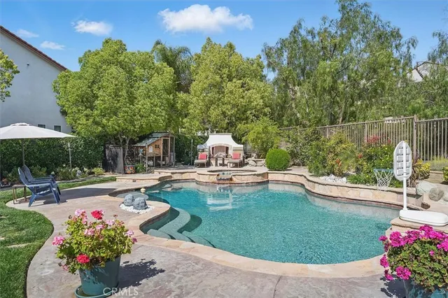 a view of a hallway to a livingroom with wooden floor and stairs
