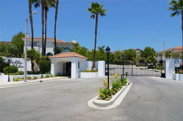 an aerial view of residential houses with outdoor space and city view