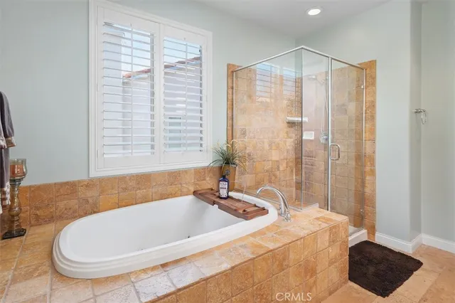 a spacious bedroom with a bed and a chandelier