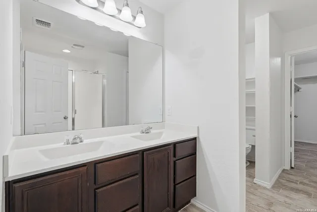 a bathroom with a sink double vanity and a mirror