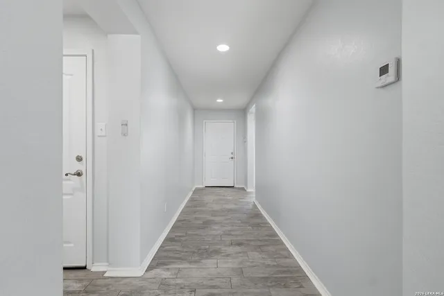 a view of hallway with wooden floor
