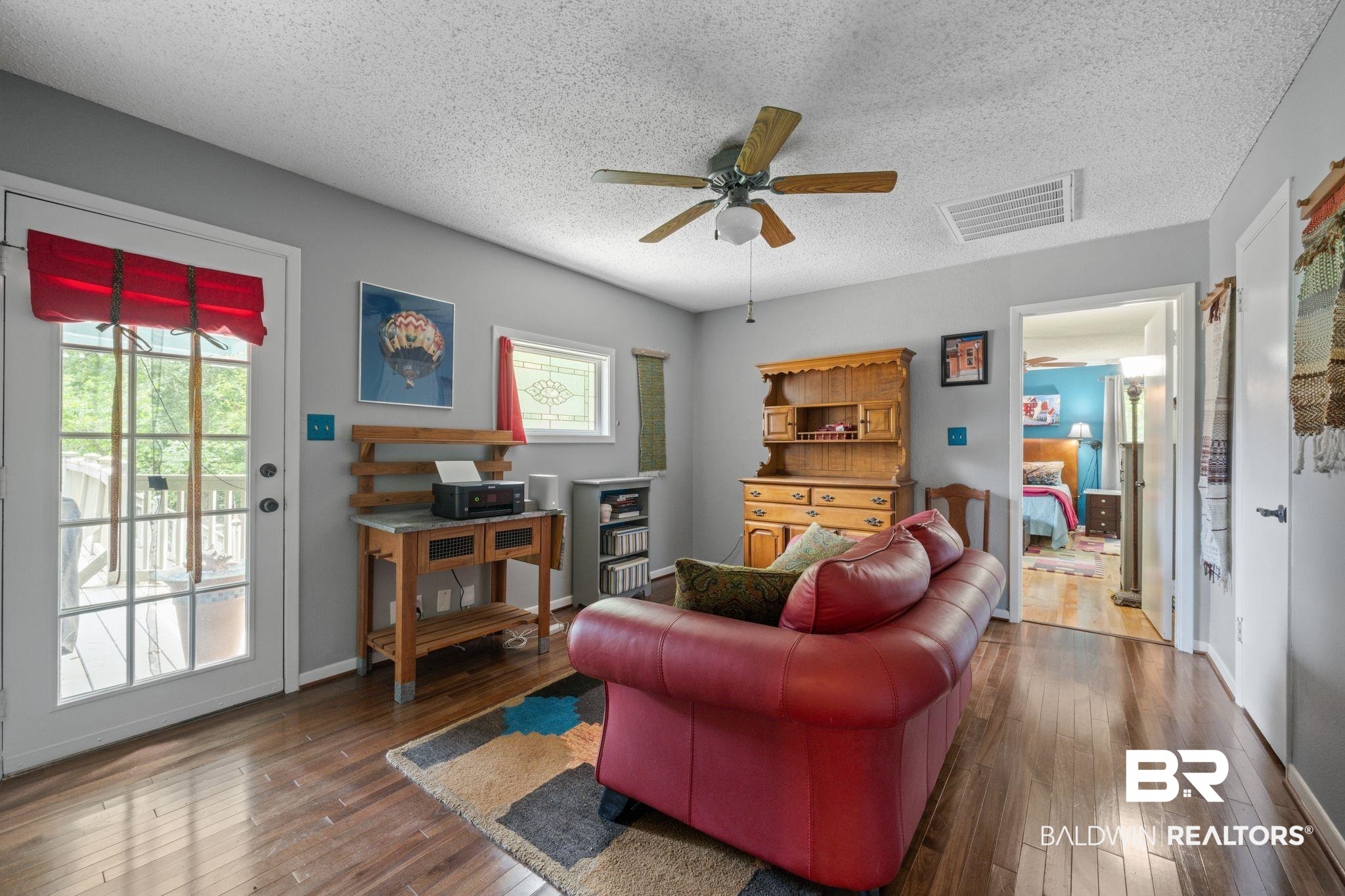 40 Caisson Trace Daphne, AL 36527 - Photo 23 of 54 Den featuring a healthy amount of sunlight, ceiling fan, and dark wood-type flooring